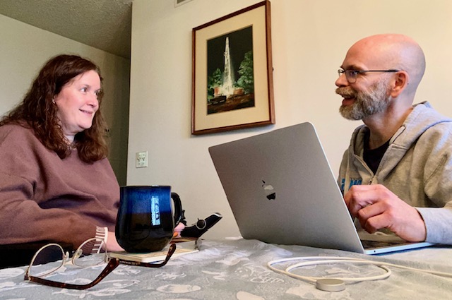 Dan and Jennifer Digmann sitting together at home discussing healthcare decisions, reflecting the financial realities of living with Multiple Sclerosis