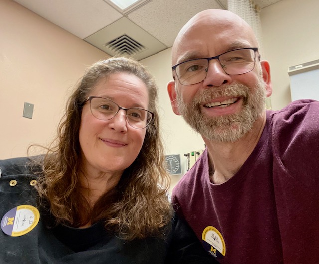 Dan and Jennifer Digmann smile together in a neurology exam room before discussing MRI results and ongoing Multiple Sclerosis care.