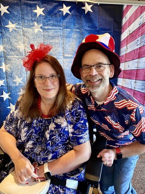 Jennifer Digmann and Dan Digmann smile together in patriotic red, white, and blue attire during Immanuel Lutheran Church's America's 250th birthday celebration after worship.