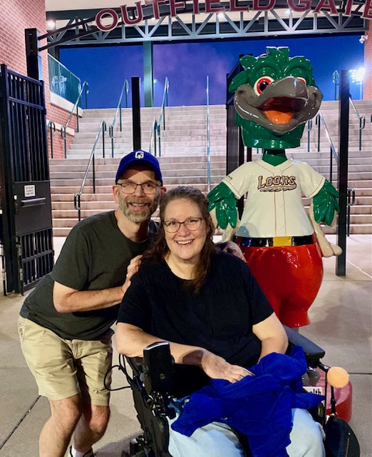 Dan and Jennifer Digmann smiling together after a baseball game while discussing aging with multiple sclerosis in Episode 105 of A Couple Takes on MS.