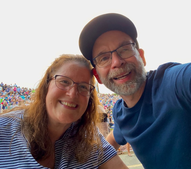 Jennifer and Dan Digmann smile together at Pine Knob Music Theatre before the Train, Barenaked Ladies and Matt Nathanson concert.