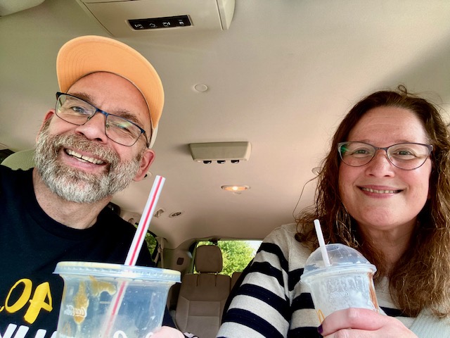 Jennifer and Dan Digmann smiling together in their vehicle while living with Multiple Sclerosis